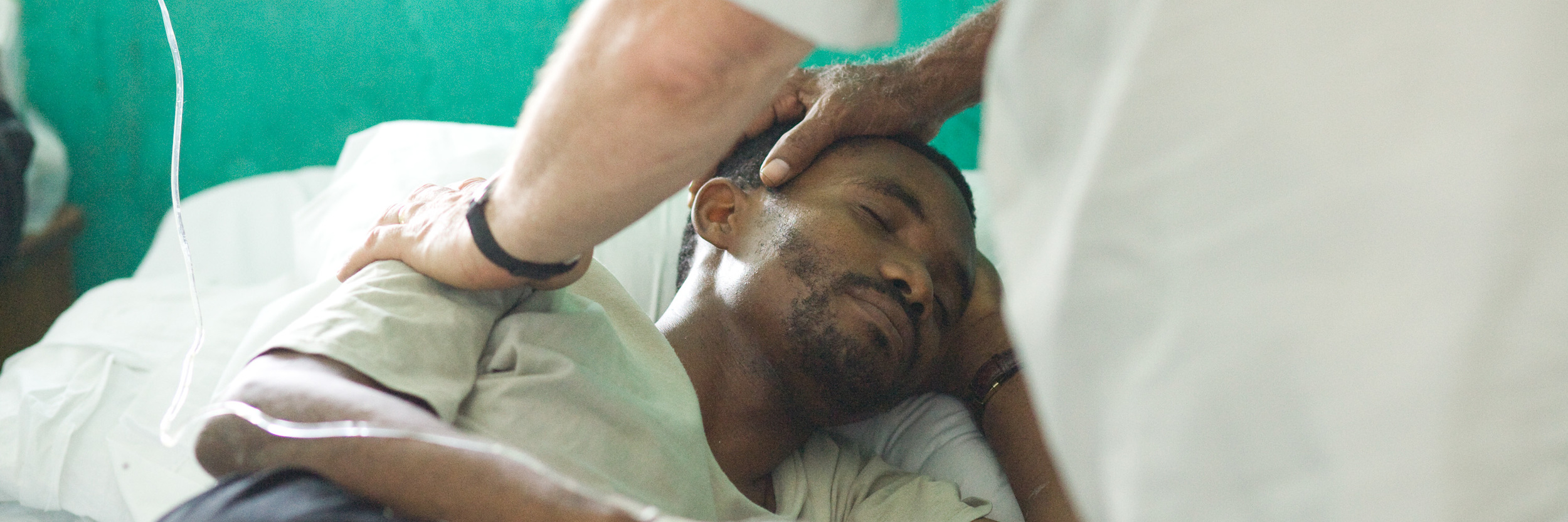 Prayer for Pastor in Les Cayes Hospital slider.jpg