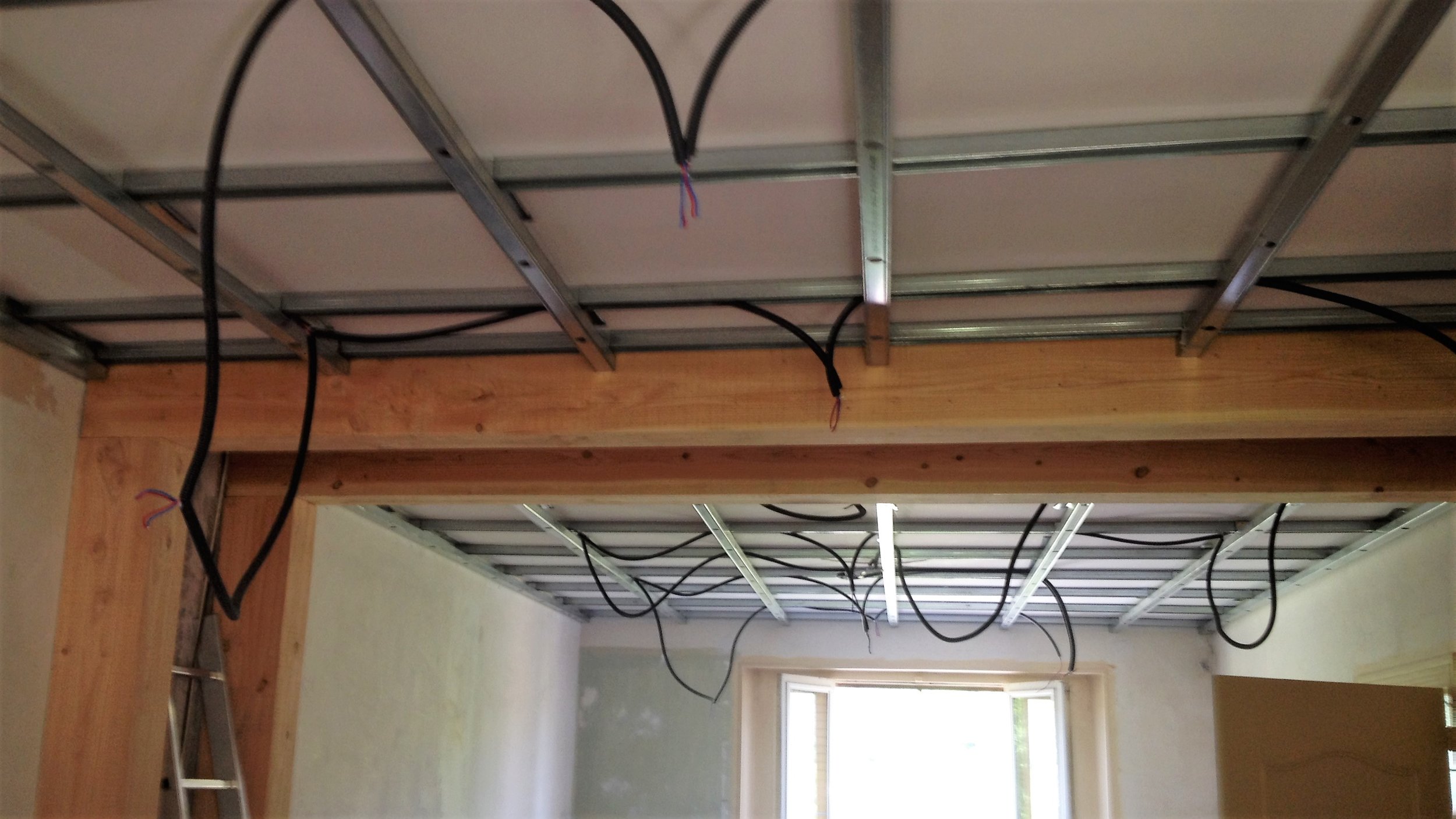 Remove the wall to double the size of the living room. Uprights and square cut beams in Douglas.