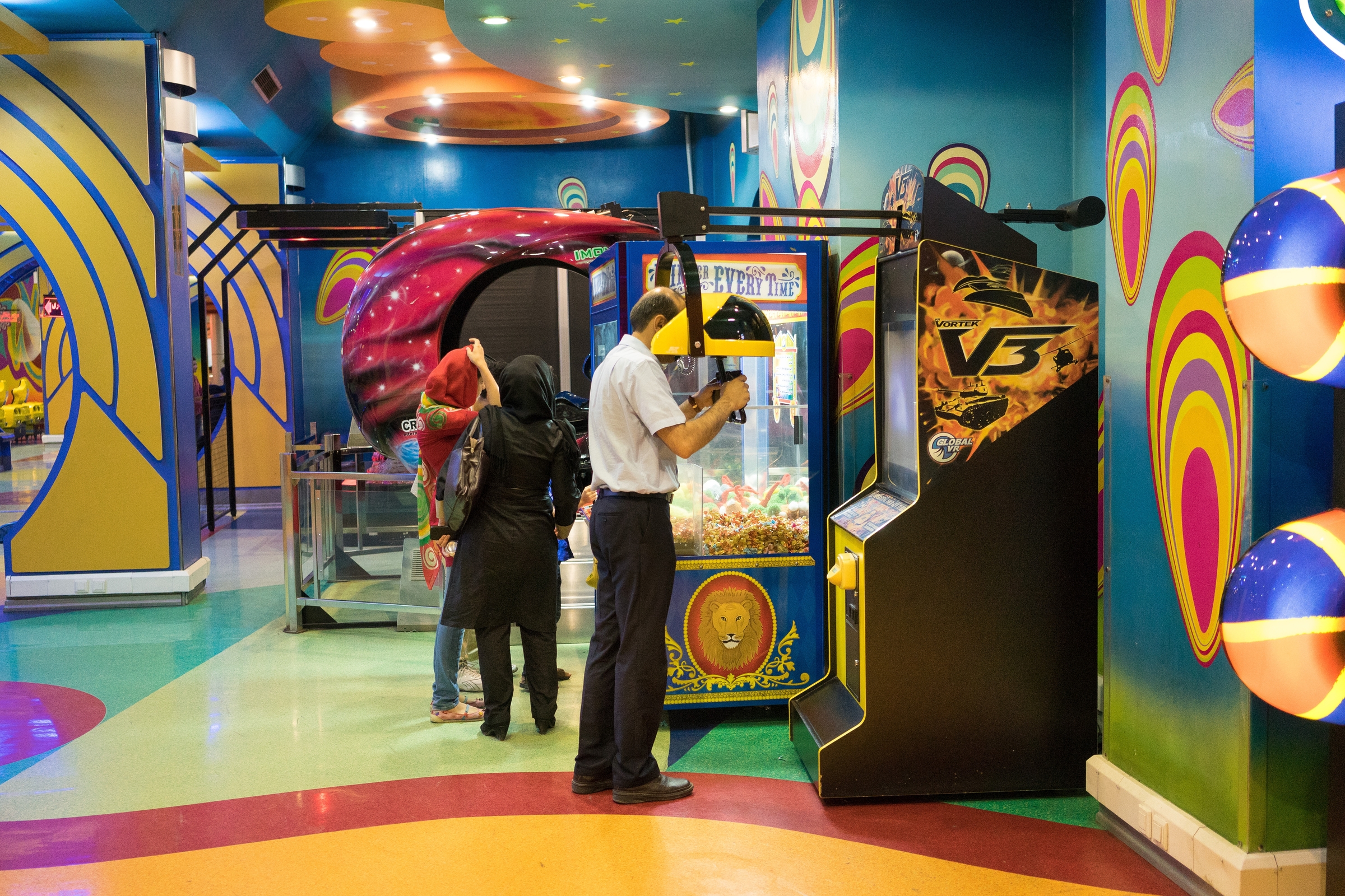  A man plays a video game at a mall in Shiraz. Such arcades are a common feature of malls, as they increase the amount of time customers spend in the facility, boosting food and retail sales.&nbsp; 