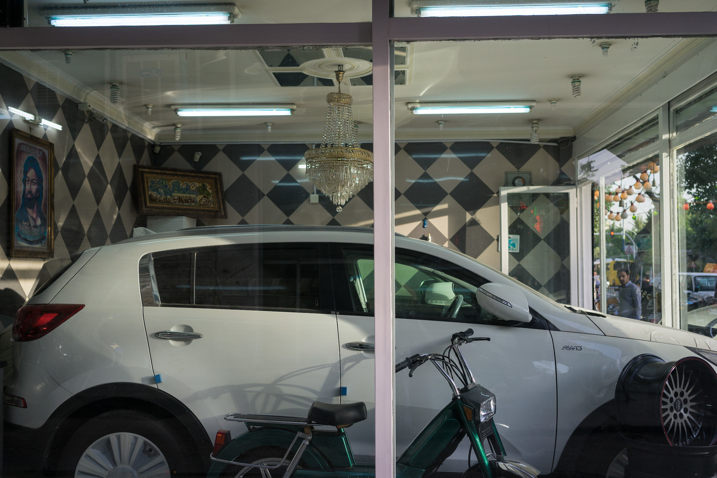  A small shop sells a late-model car in Tehran. Many of the newer, foreign cars on Iran's streets were imported to the country by individuals dealers and sold through such small shops with limited inventory. Following the lifting of sanctions, foreig