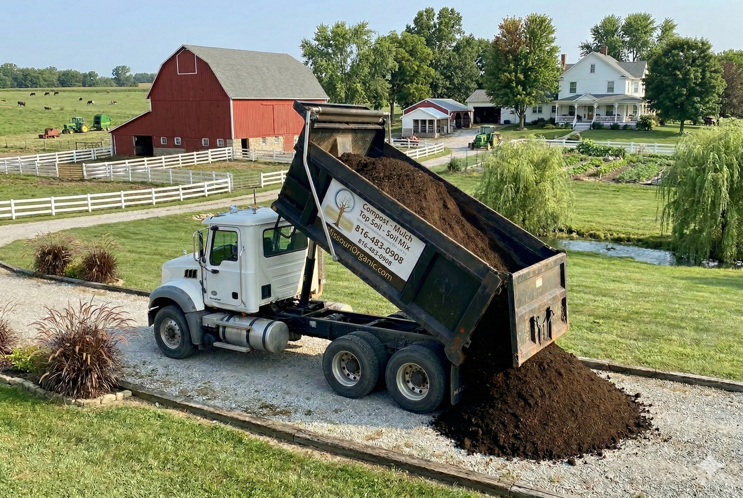 A dump truck unloading a pile of dirt and other soil materials onto a large ground area.