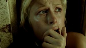 Still from horror movie House of Wax (2005; dir. Jaume Collet-Serra), showing Paris Hilton (playing the role of Paige Edwards) crying.