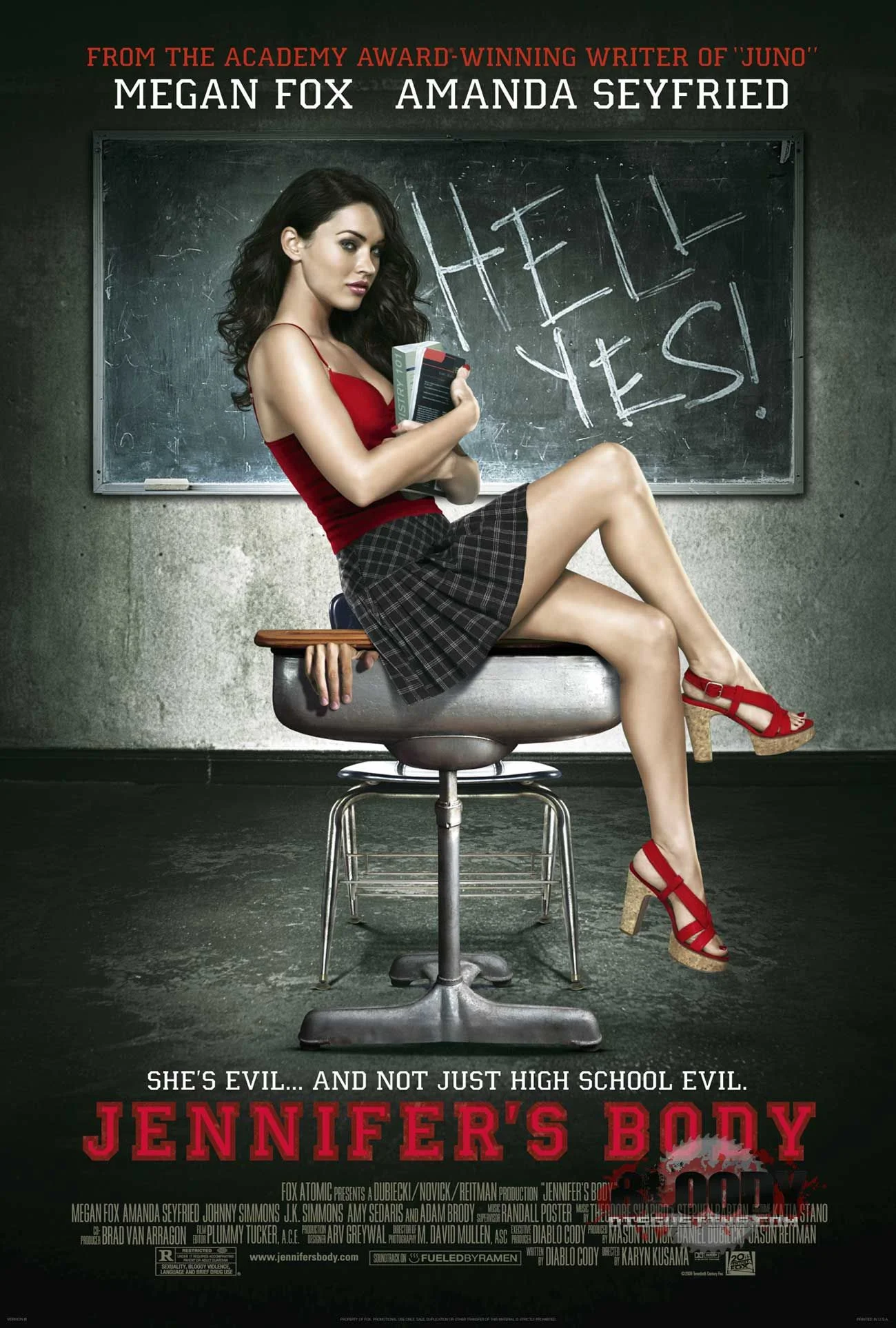 Promotional poster for Jennifer’s Body . Megan Fox (as Jennifer Check) sits on the edge of a school desk, embodying the “slutty schoolgirl” trope, side-on to the viewer in a short skirt. A human hand is visible, with the desk closed over it. “HELL YES!” is scrawled in chalk on the blackboard behind her. Strapline: “She’s evil…and not just high school evil”. Source: FilmBook .
