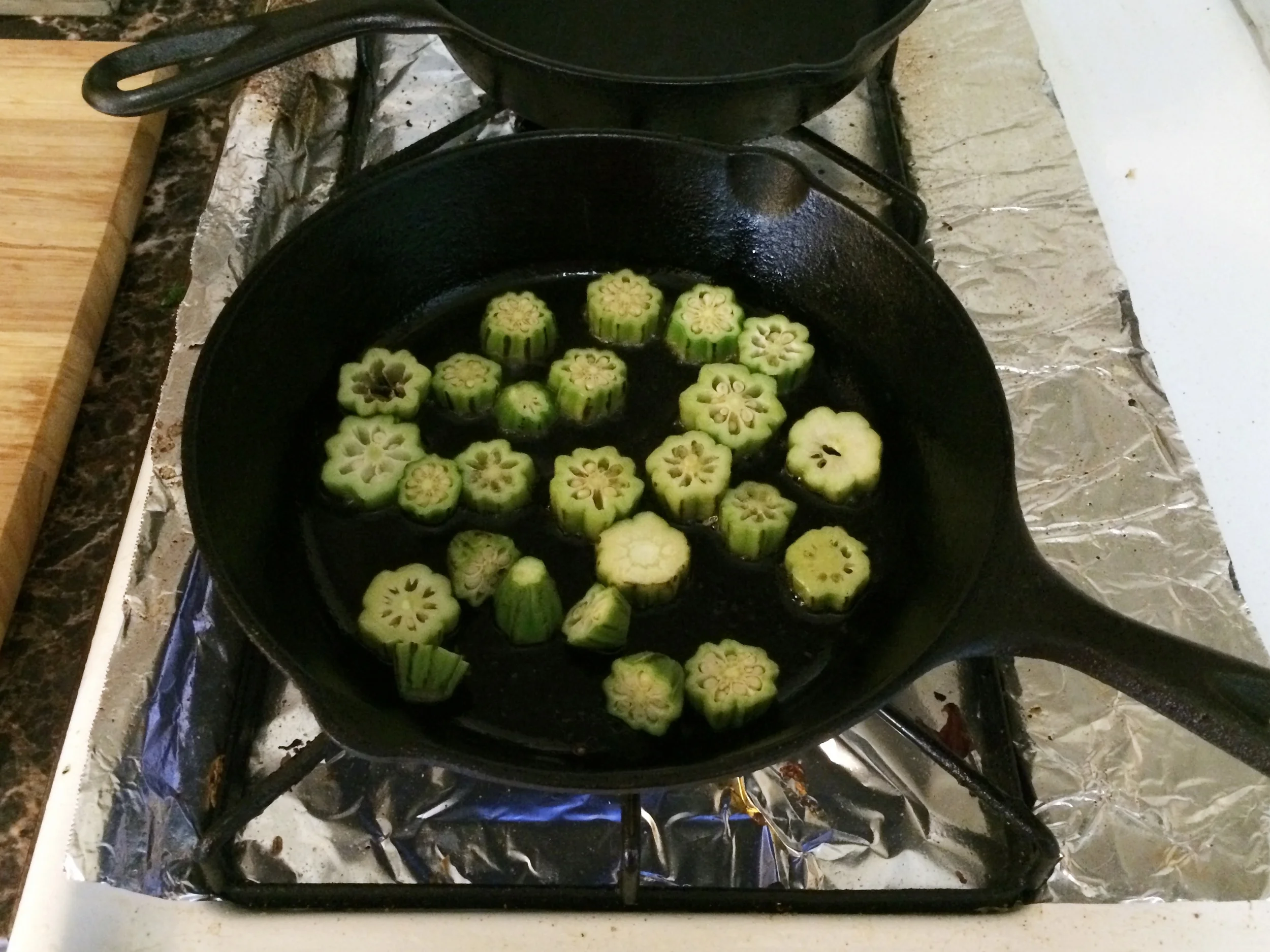 Slice the okra. heat a heavy pan with oil. once the oil is hot, around 320 degrees, add the okra and quickly fry it until golden.
