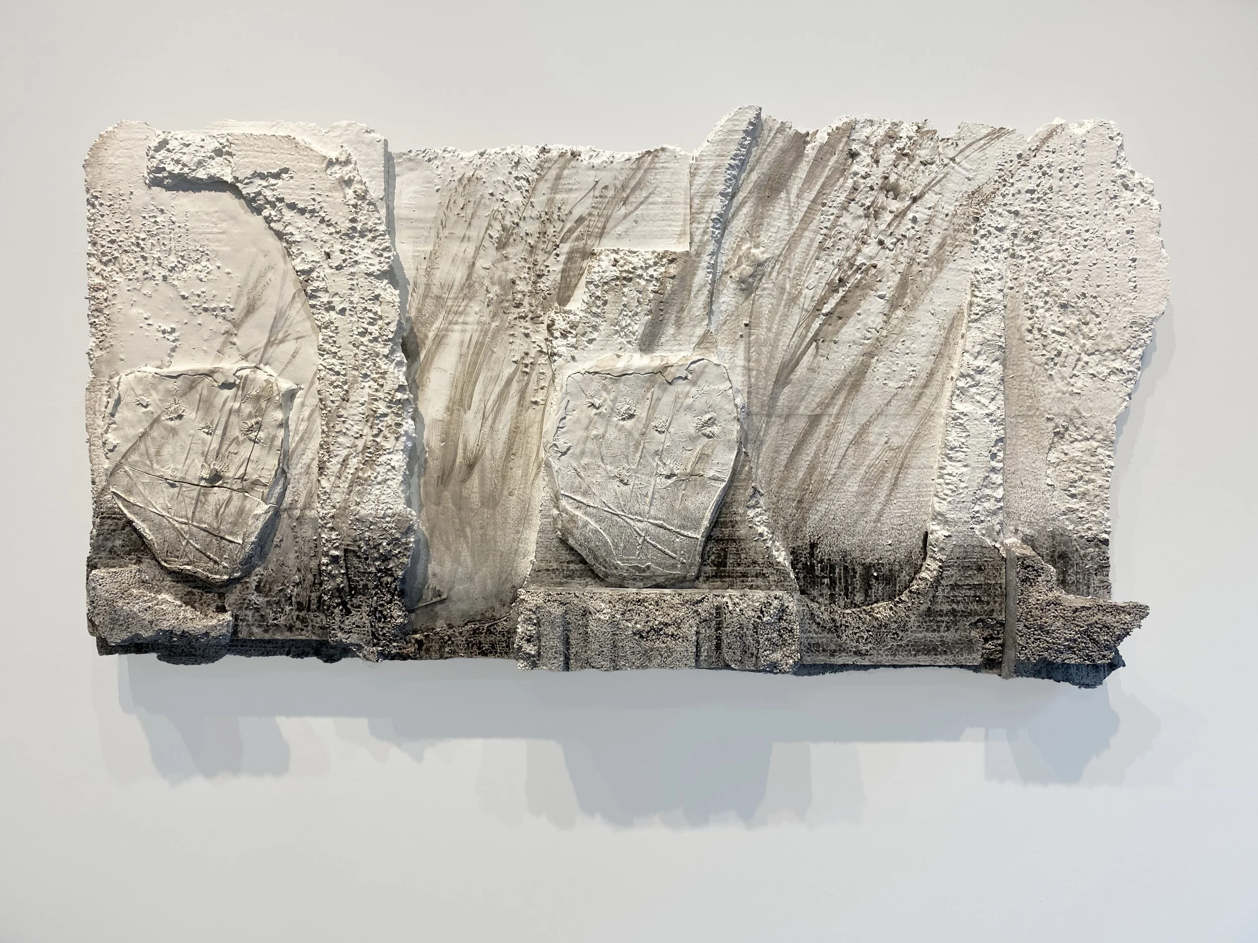 Floodlines, 2025, Plaster, acrylic, watercolor, oil paint and recycled styrofoam, 26 x 49 x 4 inches
