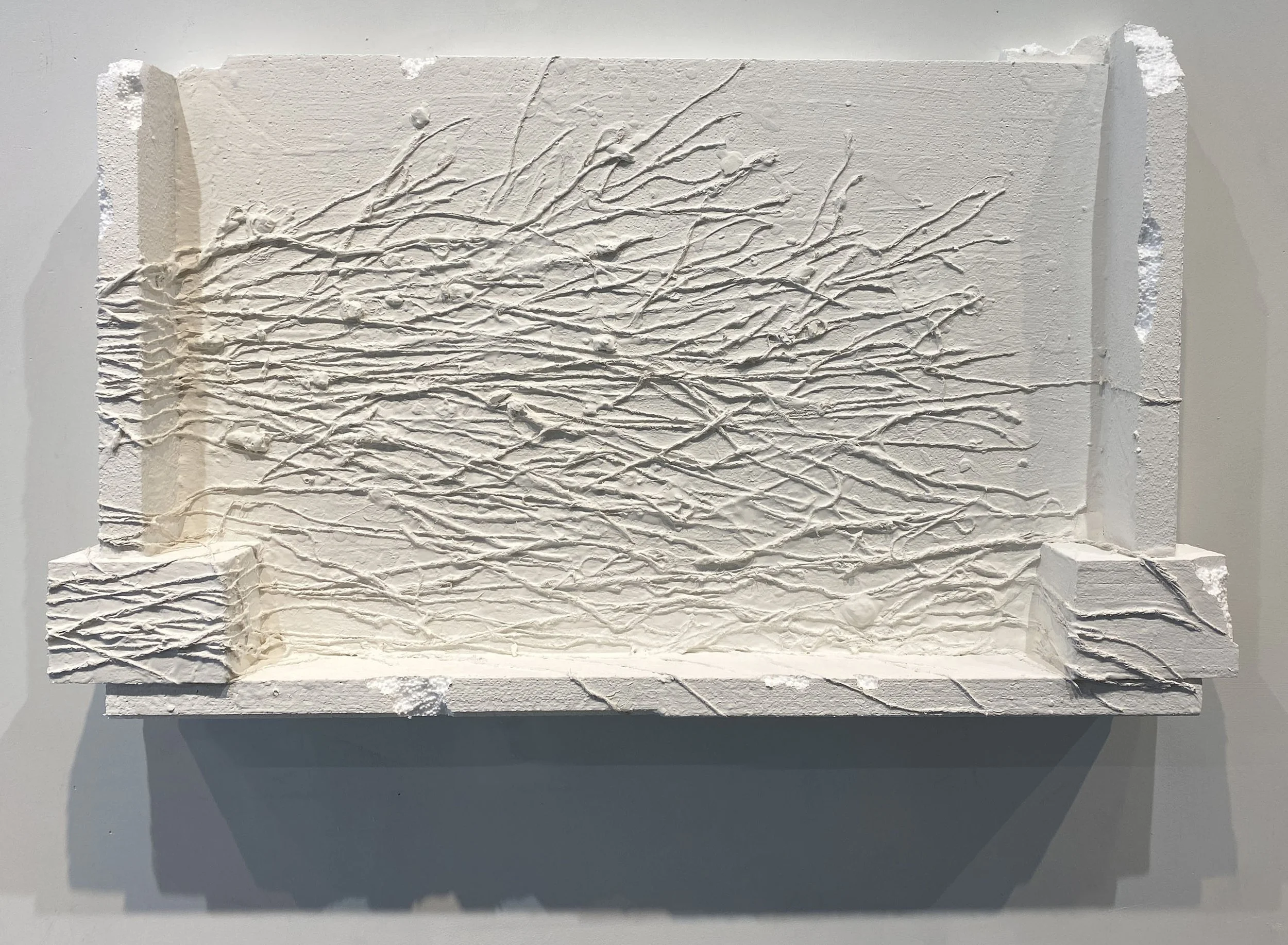 Tipping point, 2025, Recycled styrofoam, plaster, burlap, acrylic, 23 x 38 x 3 inches