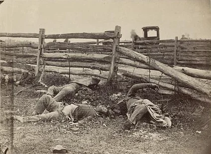 View of the Battlefield of Antietam. Four dead Confederate soldiers from General William Starke's Louisiana infantry along the Hagerstown Pike. Brady’s Album Gallery No. 567. 1862. Library of Congress.
