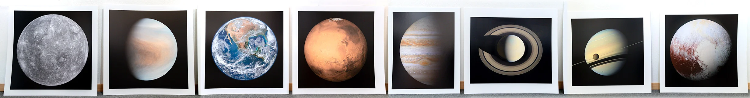 Prints along gallery wall prior to installation.