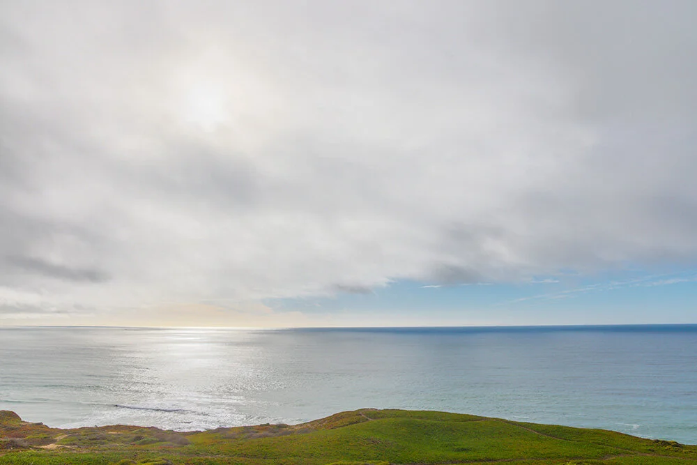 Blue-line on Sea. 2021. Canon EOS R5, RF24-105mm F4 L IS USM.I saw this dark blue line on the horizon from my deck and rushed down to the seaside cliffs. I didn't expect the wonderful sun breaking through the clouds and glare off the water as well. …
