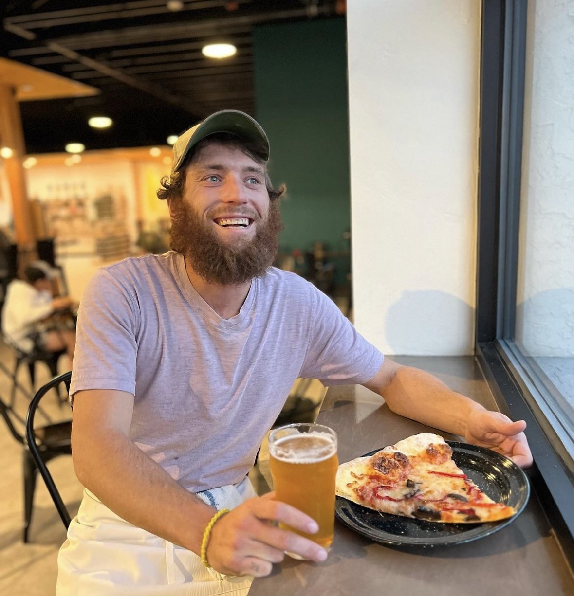 Salmon bearded fello with beer and pizza.jpeg