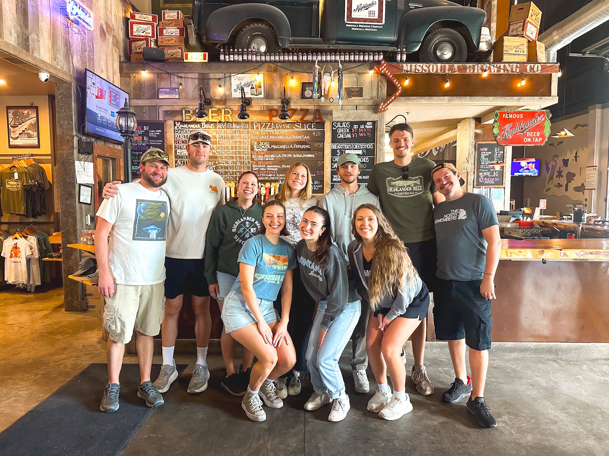 10 Highlander servers smile for a photo in the taproom