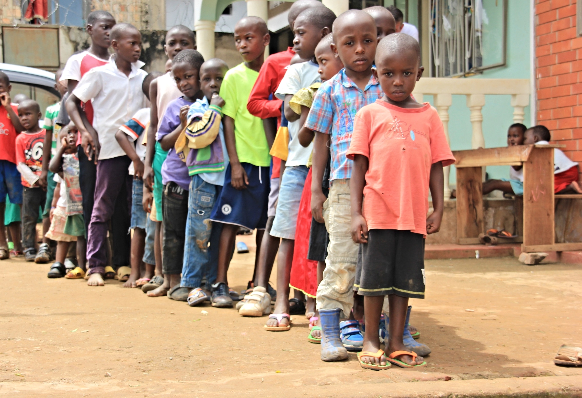 Kids between 4 and 15 waiting in line to receive their first toy ever