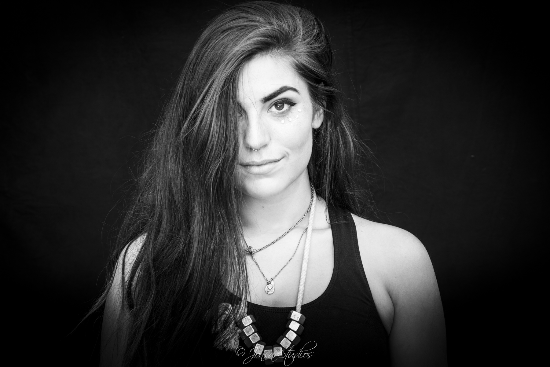 Portrait of girl with long hair photographed on black background