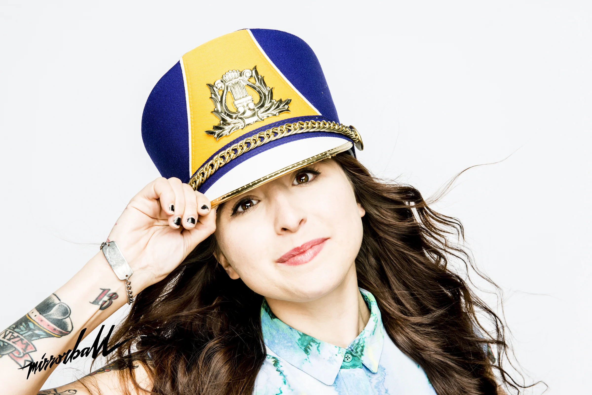 Portrait of Woman with long hear on white background wearing Drum Majorette Hat