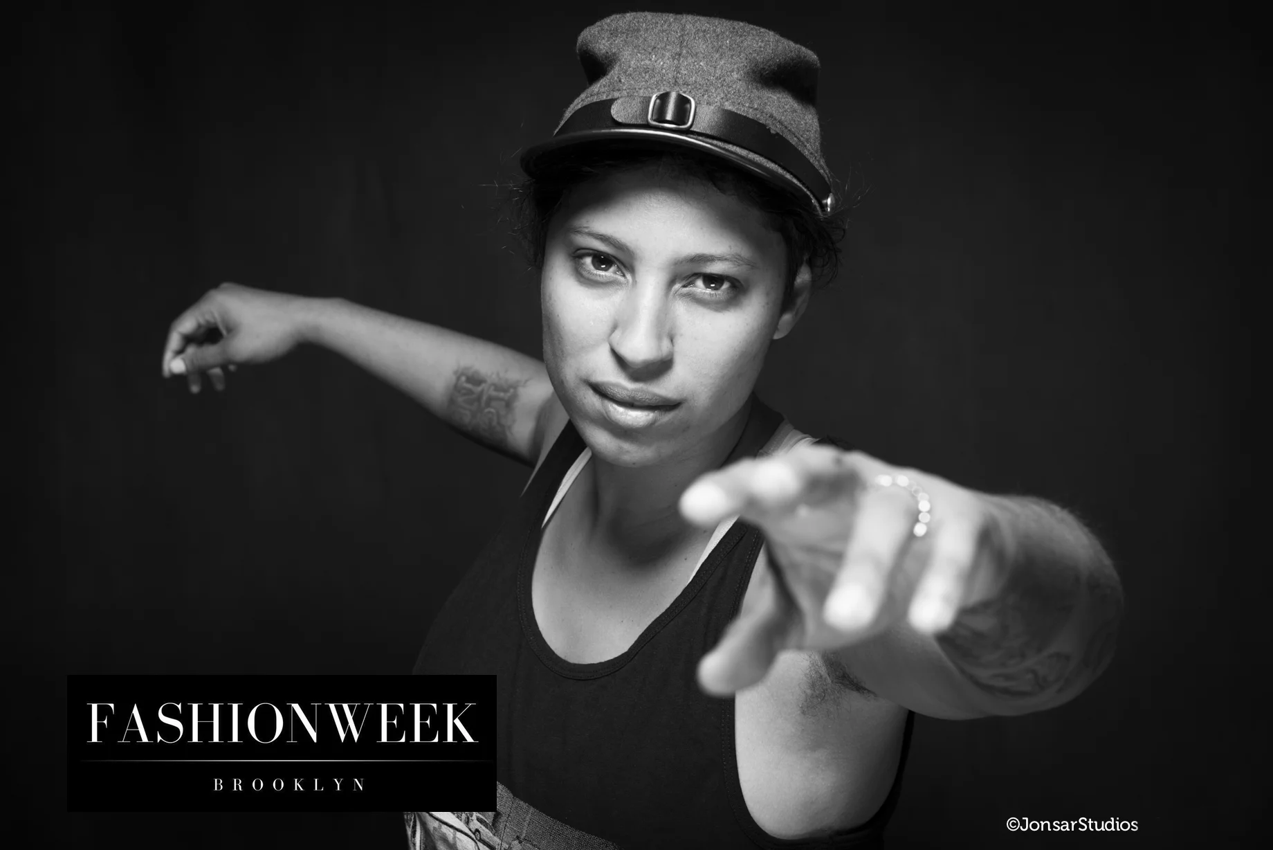 Black and White Portrait of Woman on Black Background wearing a soldier's cap