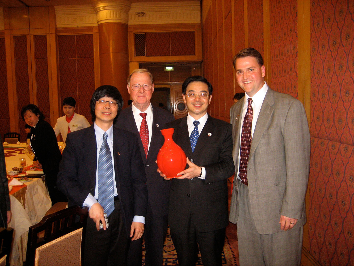   Ben Owen III (far right) presents a vase to the Governor of Hunan Province.  