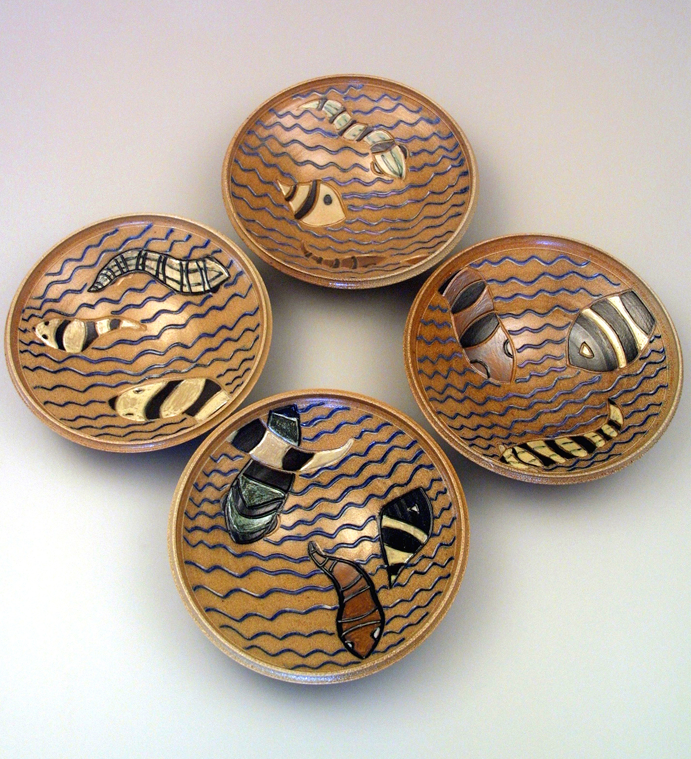   Four commissioned salt-glazed bowls with painted slips.  