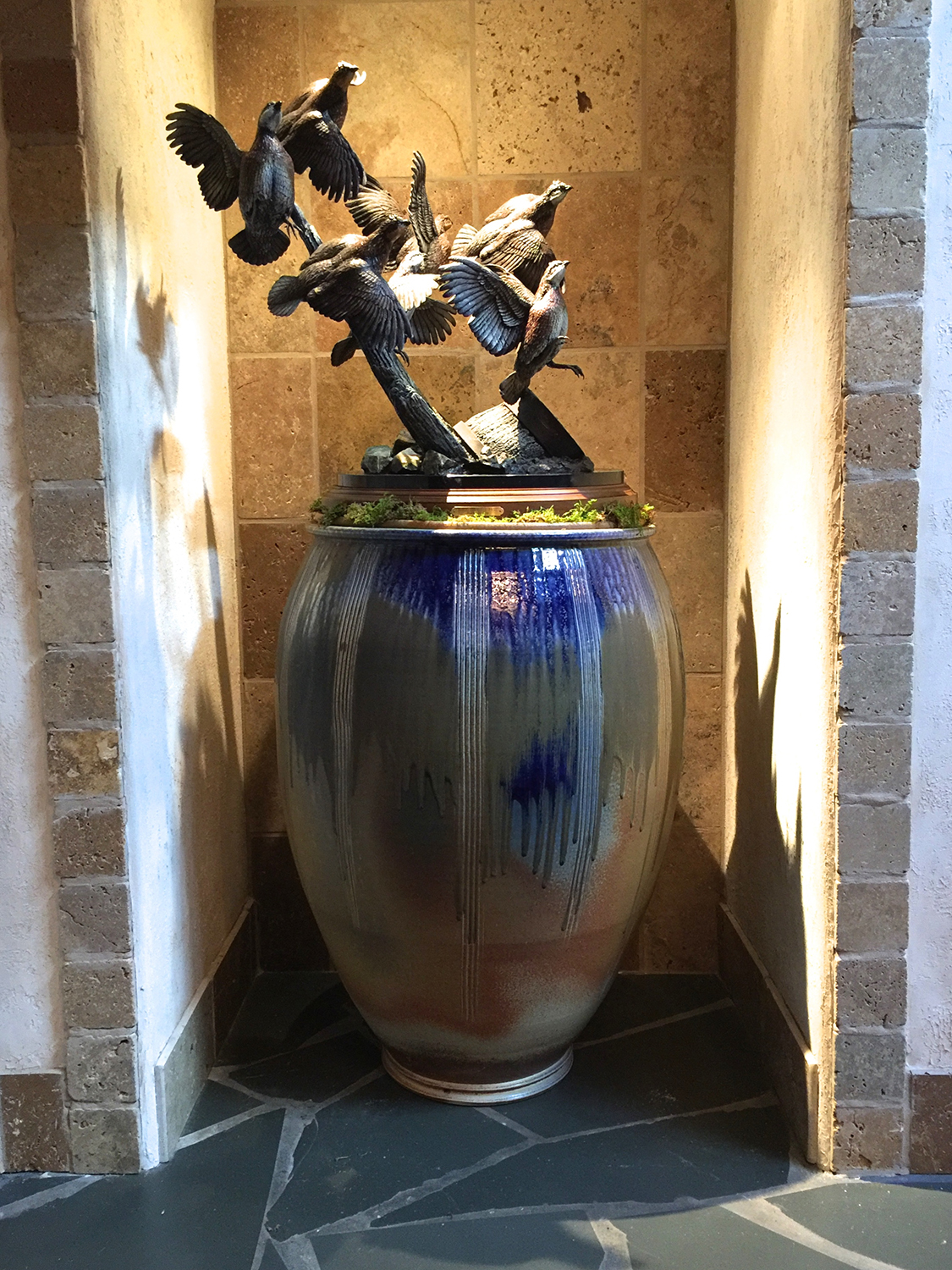   A sculpture of birds in flight is anchored by a large Cobalt Blue and Ash glazed pot in this home in Pinehurst, NC.  