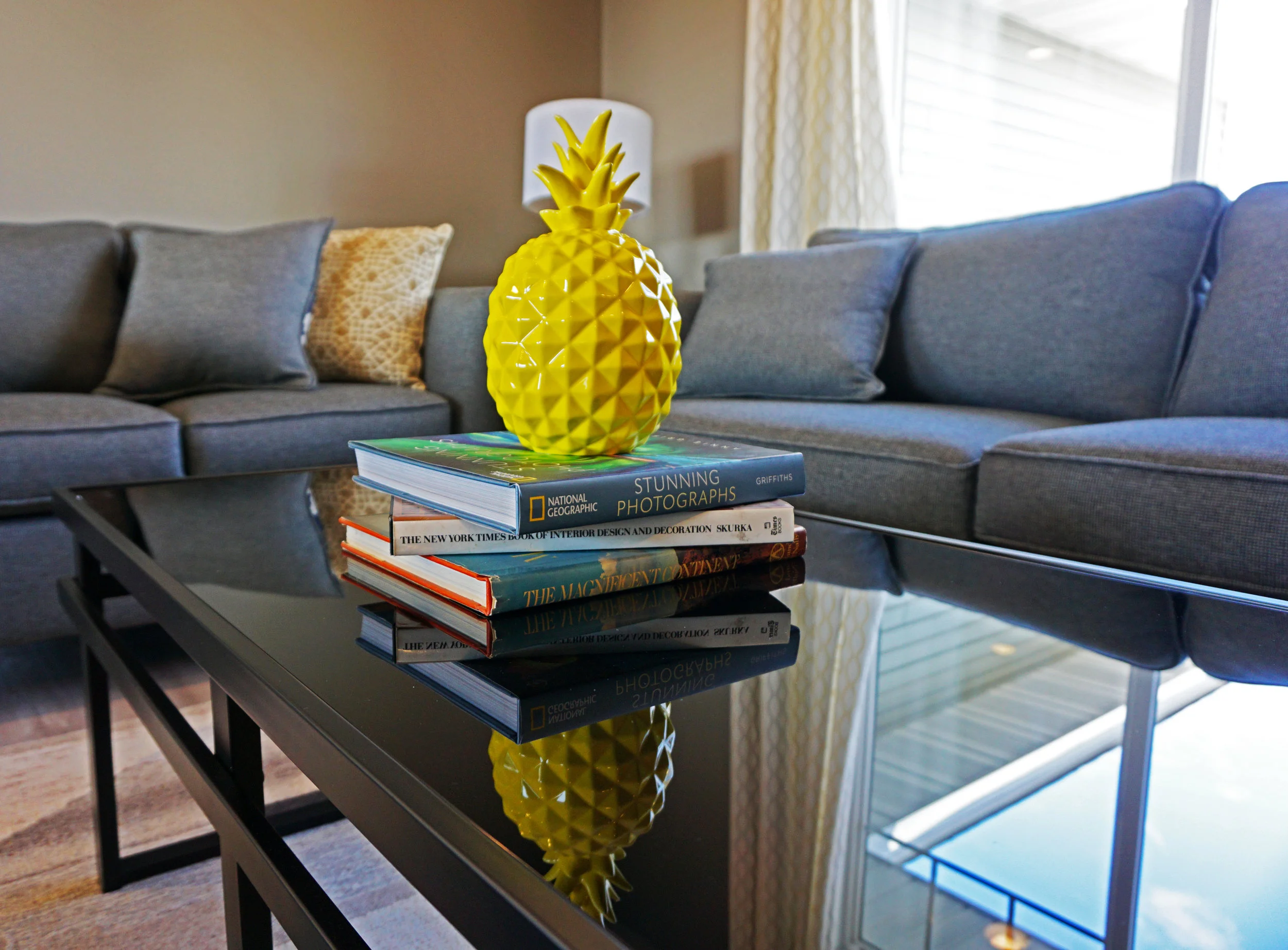 Keep it simple: Choose a few large, colorful photo books for the coffee table and add a quirky ceramic piece for a pop of color and whimsy.