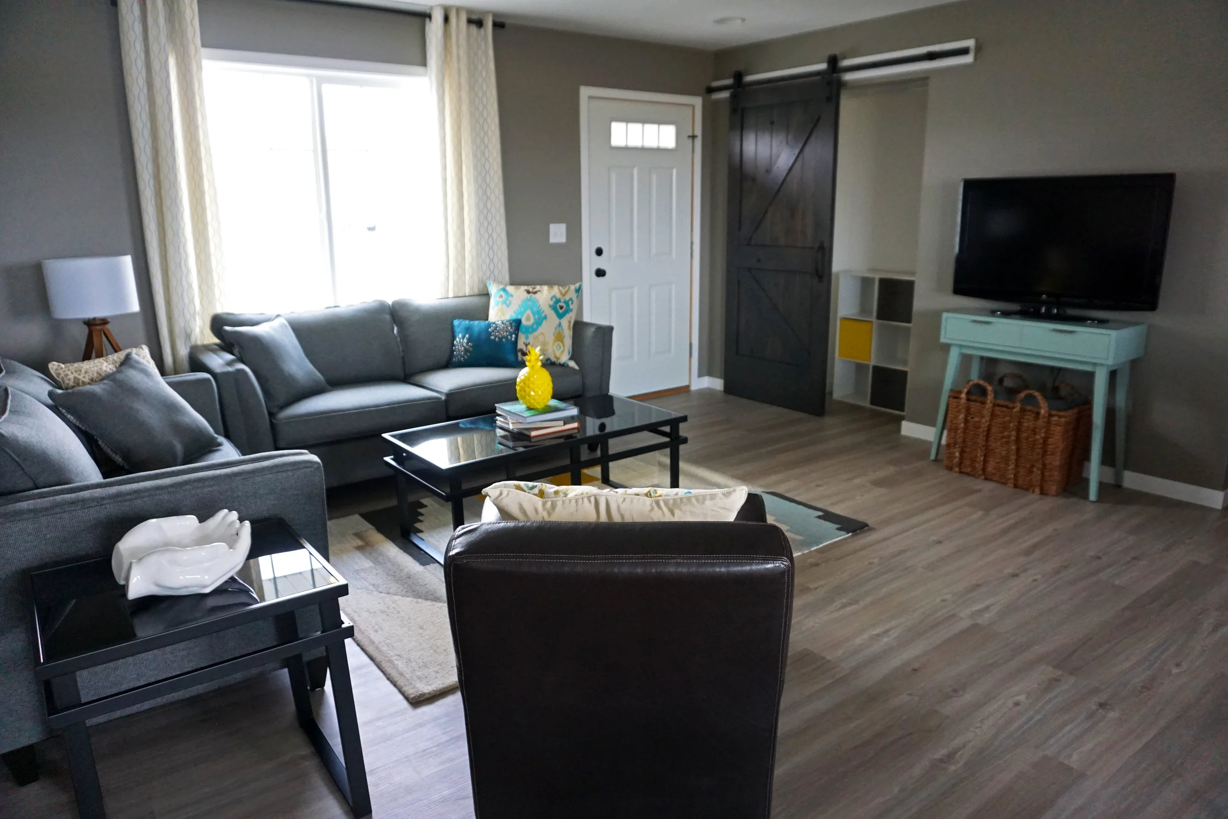 This double-duty living room/entry needs definition and style. A thick wool rug adds warmth and separates the seating area from the front entrance.