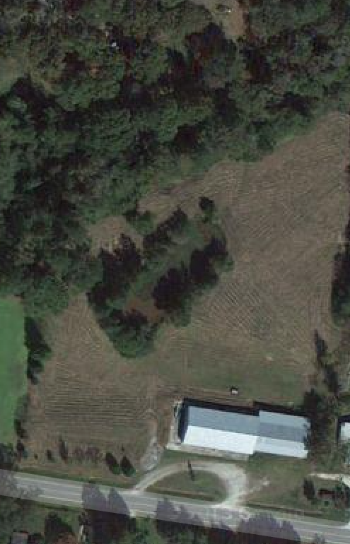 Aerial shot: 3.5 acres, warehouse, land and pond.