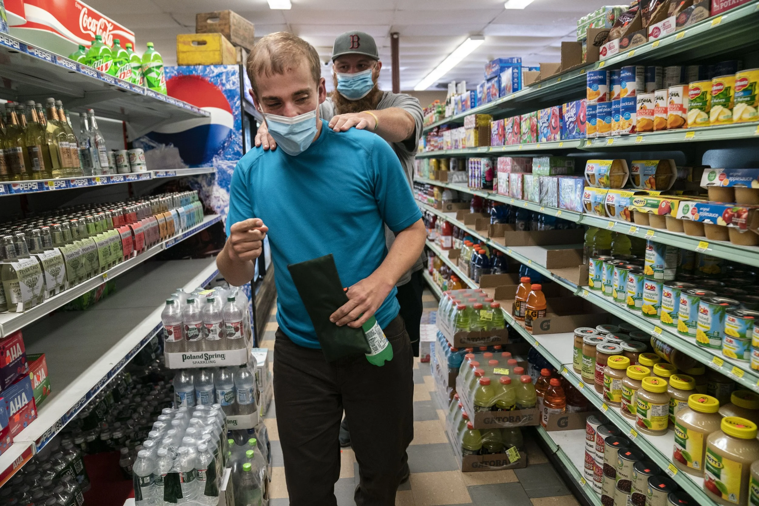  Charlie Palmer, a daytime staff member with Shared Living Collaborative, guides Andy Tranfaglia down the aisle to the sandwich section after picking out a Fresca for lunch. 