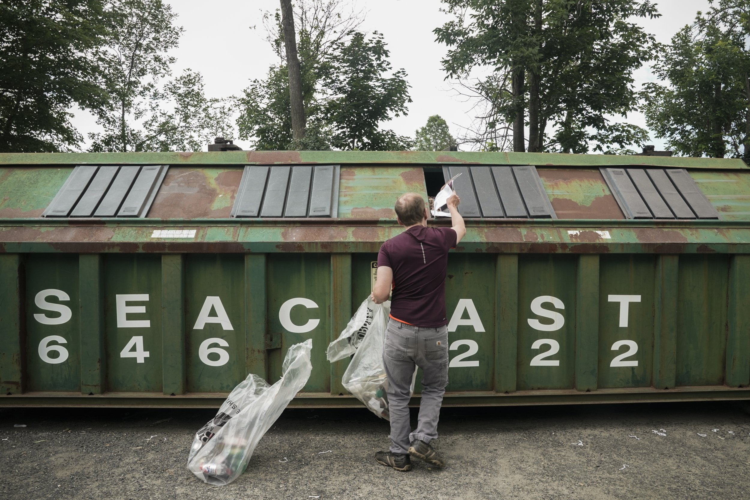  Piece by piece, Andy Tranfaglia separates and throws away the recycling at the West Newbury recycling center.  