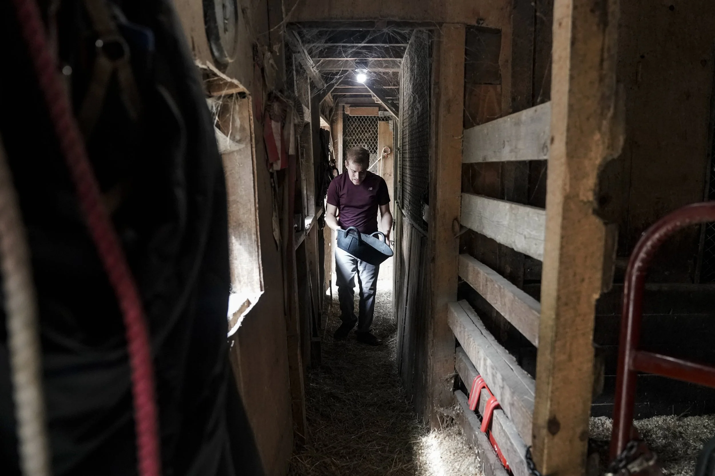 After cleaning out the barn stalls, Andy Tranfaglia helps feed the ponies at a local barn as part of his work program. 