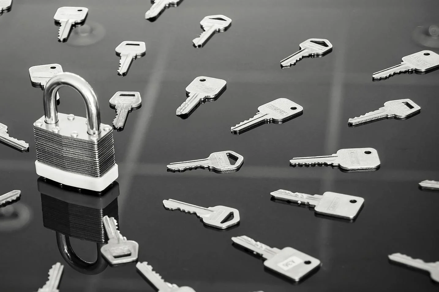 padlock with many different keys surrounding it.jpg