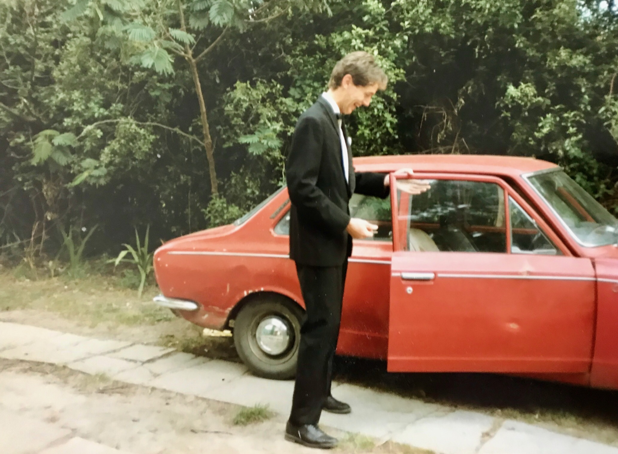 Manuel and his trusty rusty red corolla