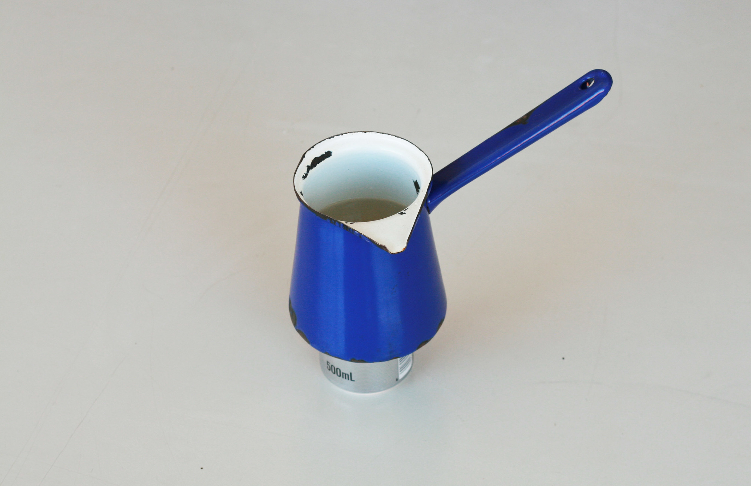 Place pot or pan ontop of stove, use a wind shield if necessary.