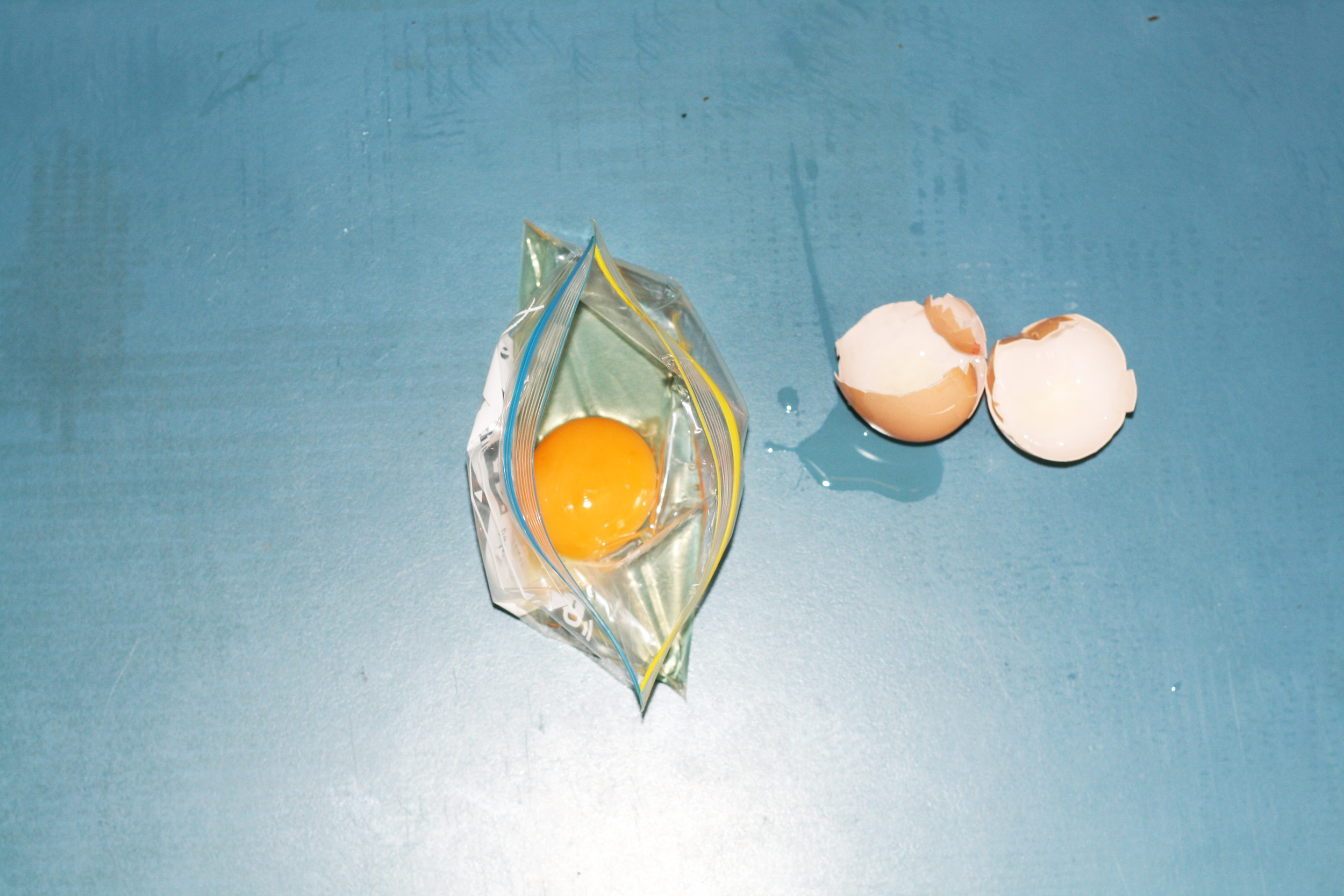 Crack eggs individually into the containers.