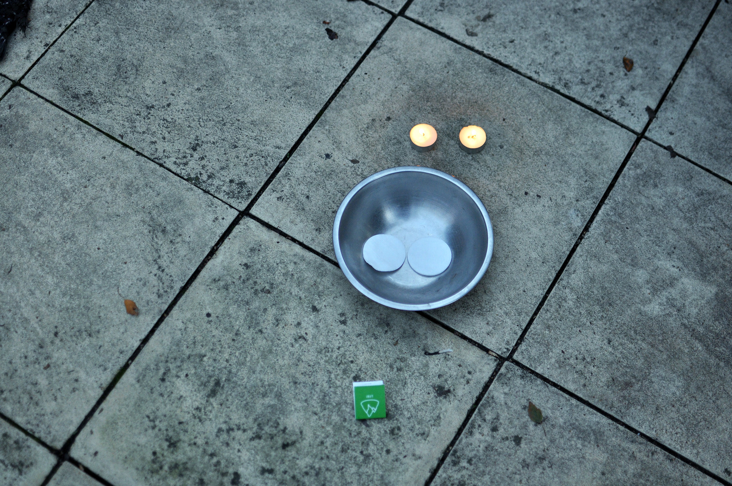  Light your tealight candles until the wax is melted and place the cotton wool pads in the heatproof bowl. 