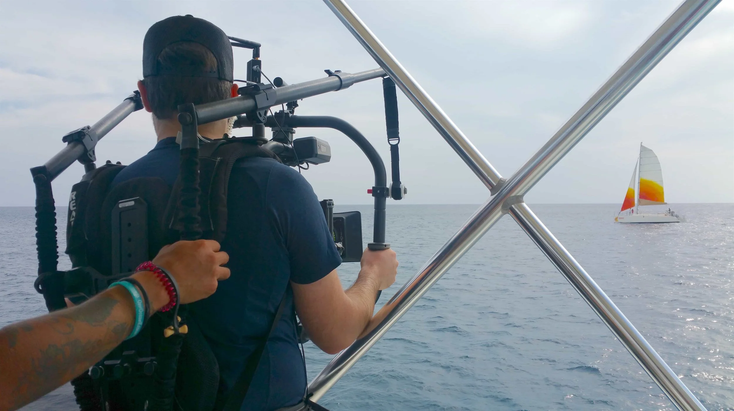 Ryan Hamelin operating Sight & Sound's Movi Pro to film the Holokai Catamaran in the distance.