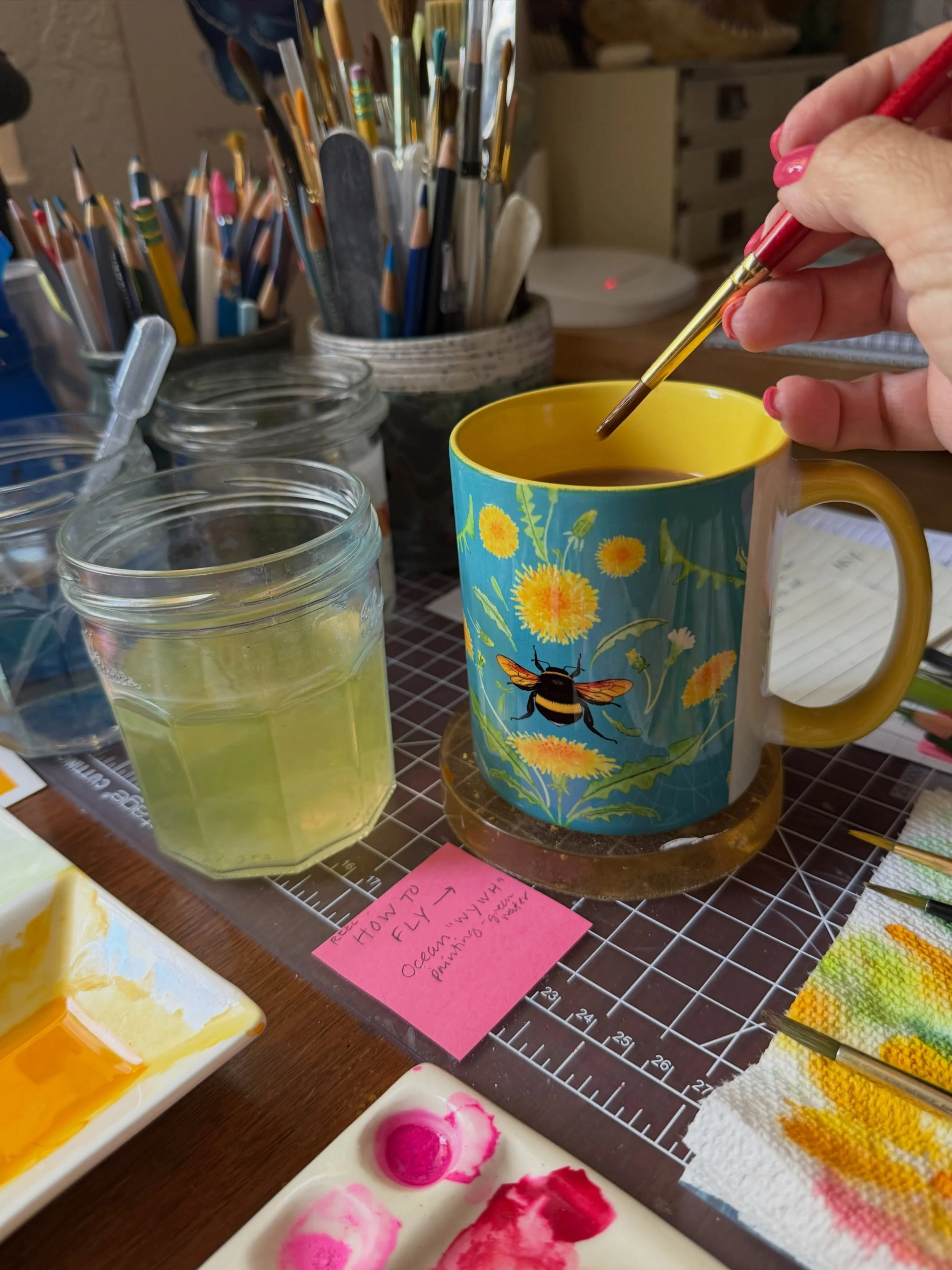 Put your coffee right next to your paint water, Live dangerously! ➡️ Scenes from my desk; a visitor; what&rsquo;s for dinner; a beautiful Arizona sunset 🌅 
Bumblebee mugs now available in my Etsy shop! NordenHaus.etsy.com ➡️ link in bio. 
#bumblebee