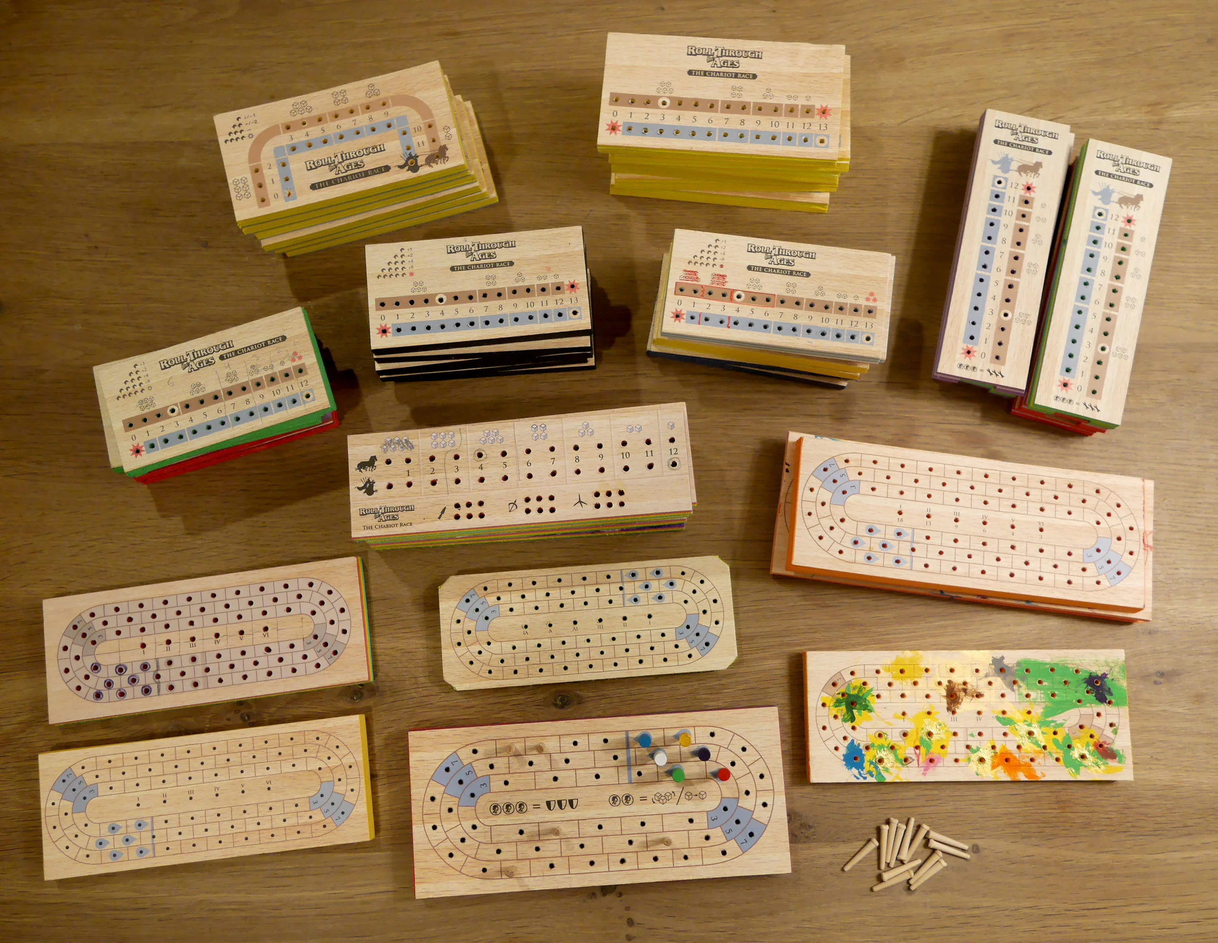 Here are some of the many pegboards I made out of foam and drilled for testing. Some of the boards were hollowed out underneath so you could keep your Fortuna coins secret from the other players. I used older boards to hold cribbage pegs while I painted them (bottom right). Not pictured are all the sets I sent out for blind-testing. I must have drilled about 5,000 holes over the course of the project.
