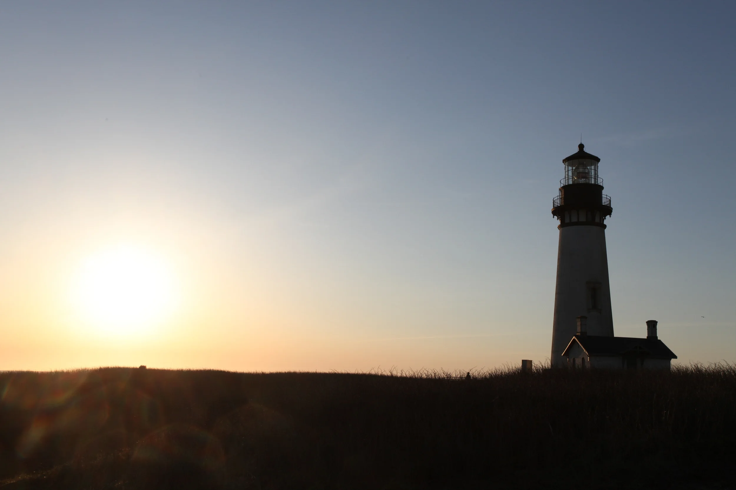 sunset at yaquina head lighthouse, oregon, usa