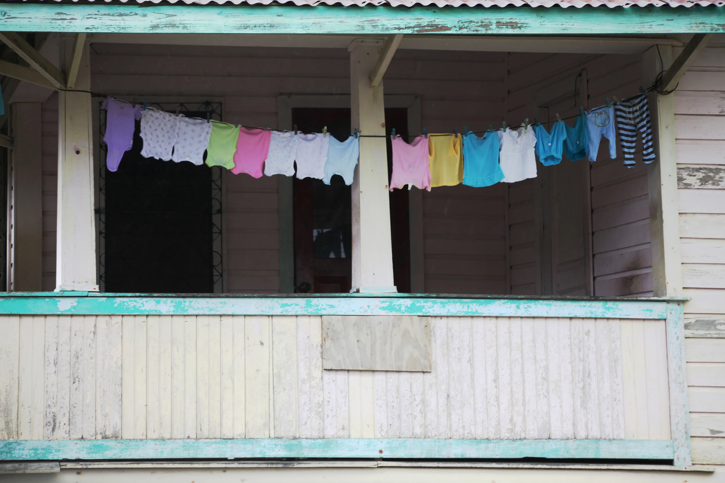 children's clothing drying on patio, roatan, honduras