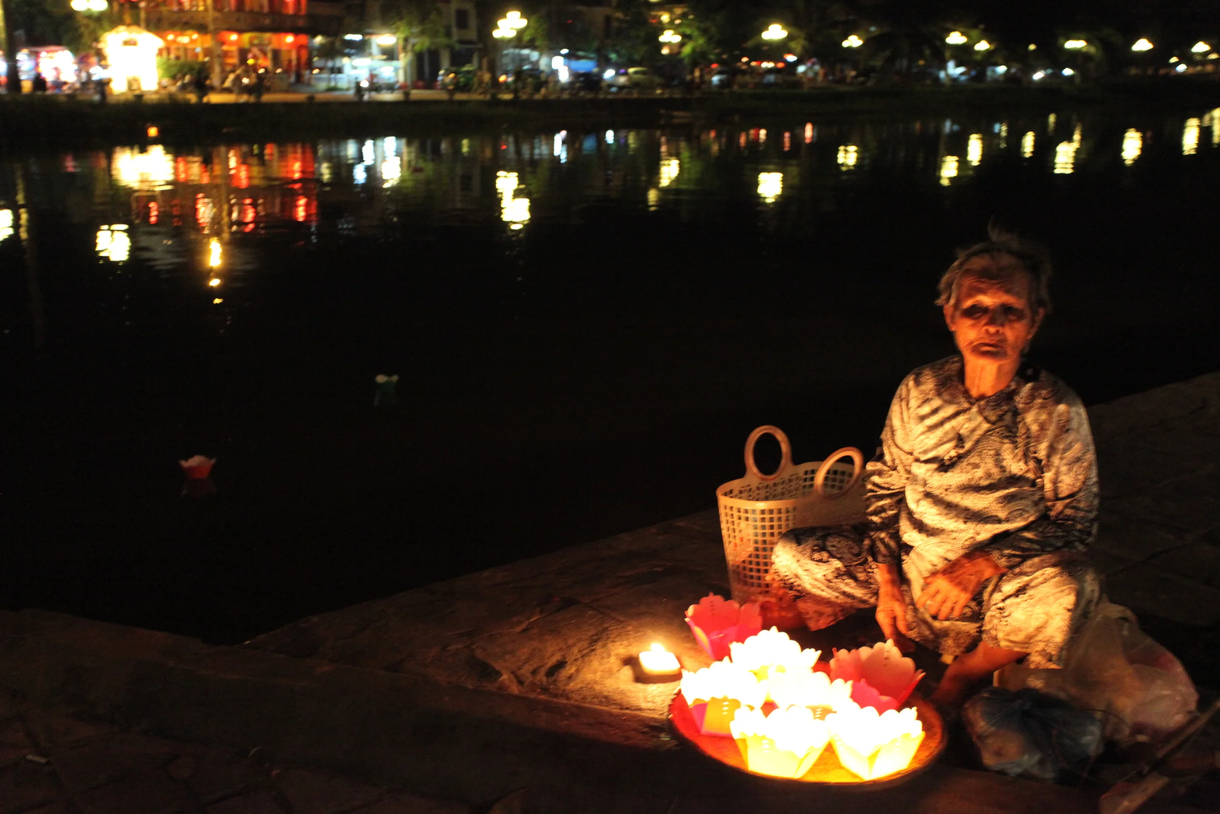 woman selling floating lanterns, hoi an, vietnam
