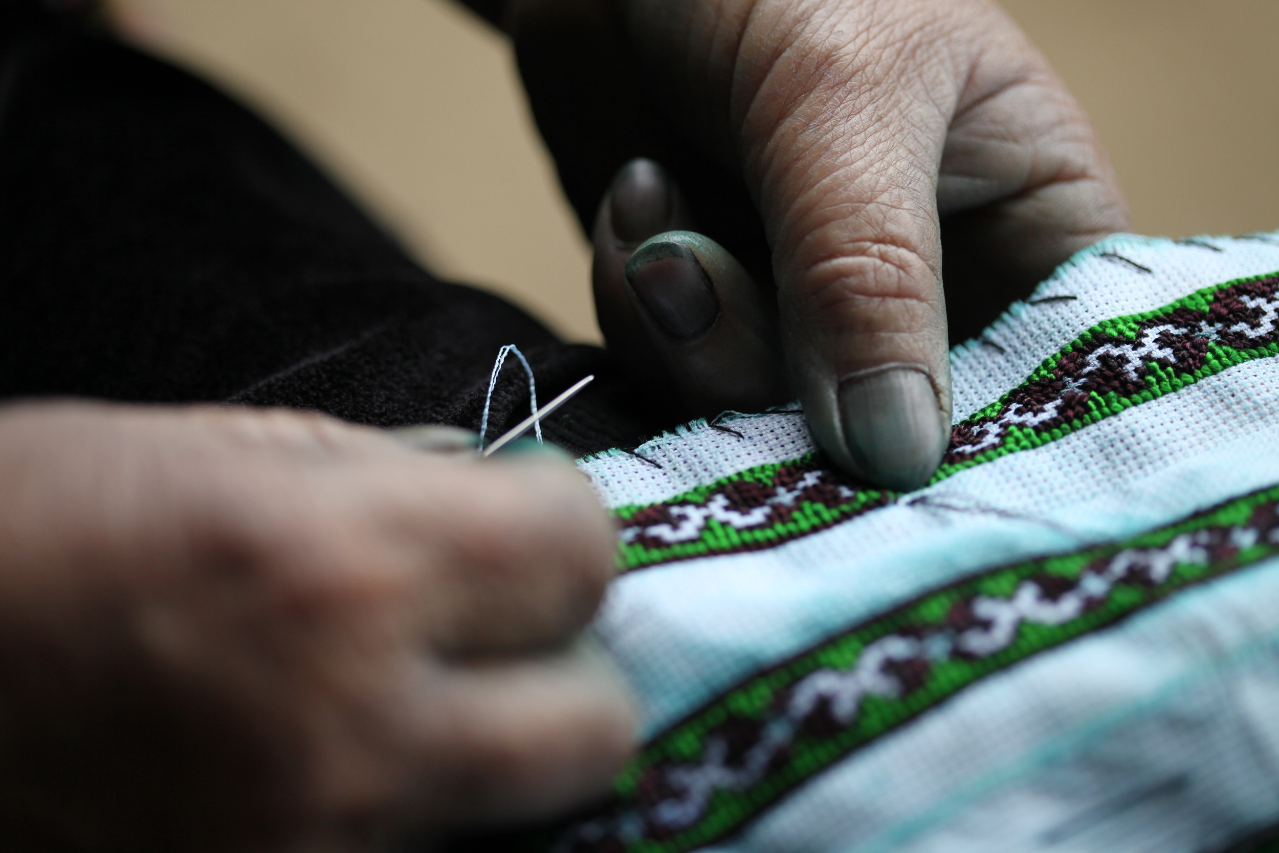 hmong woman stitching, sapa, vietnam