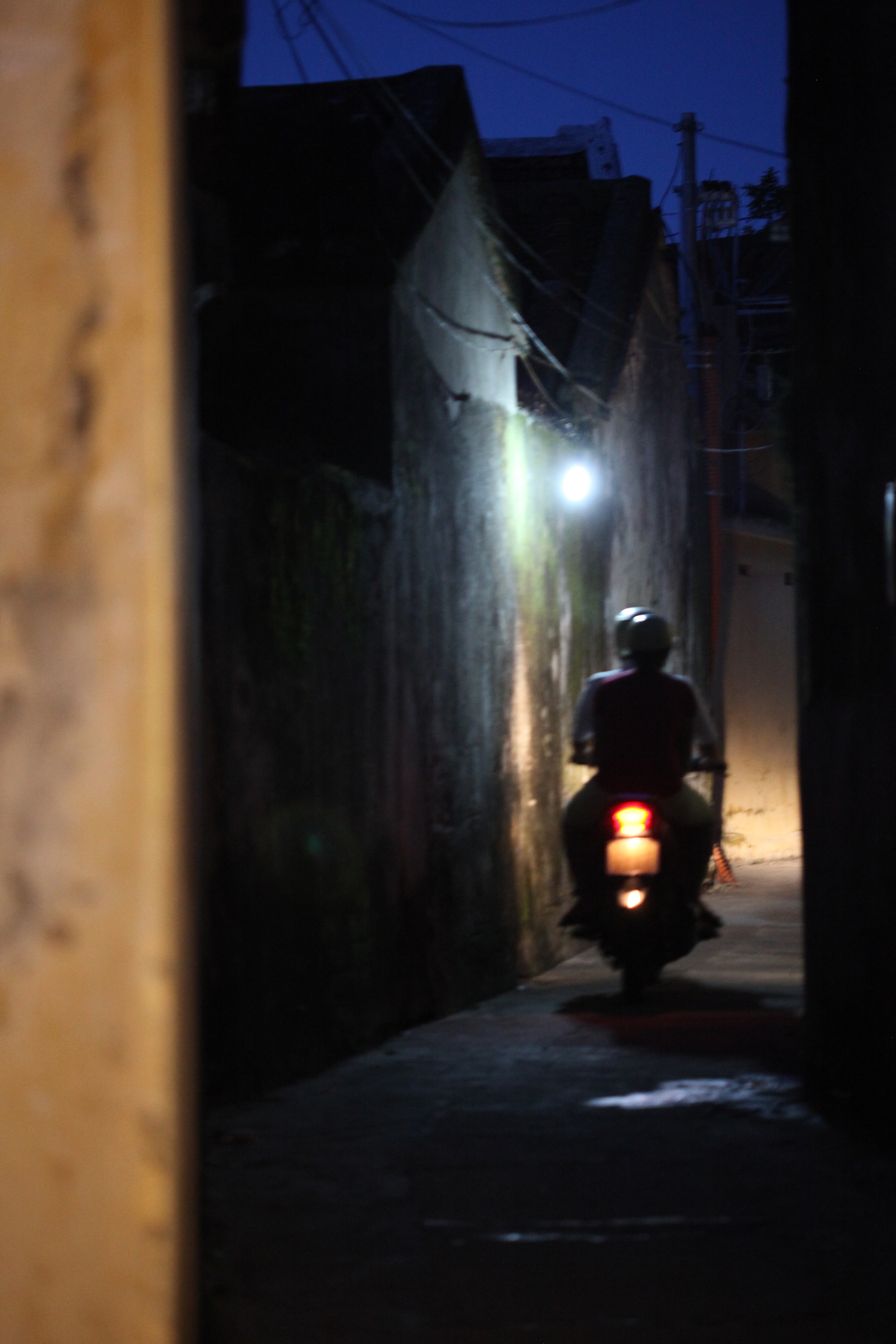 motobike through alley way, hoi an, vietnam