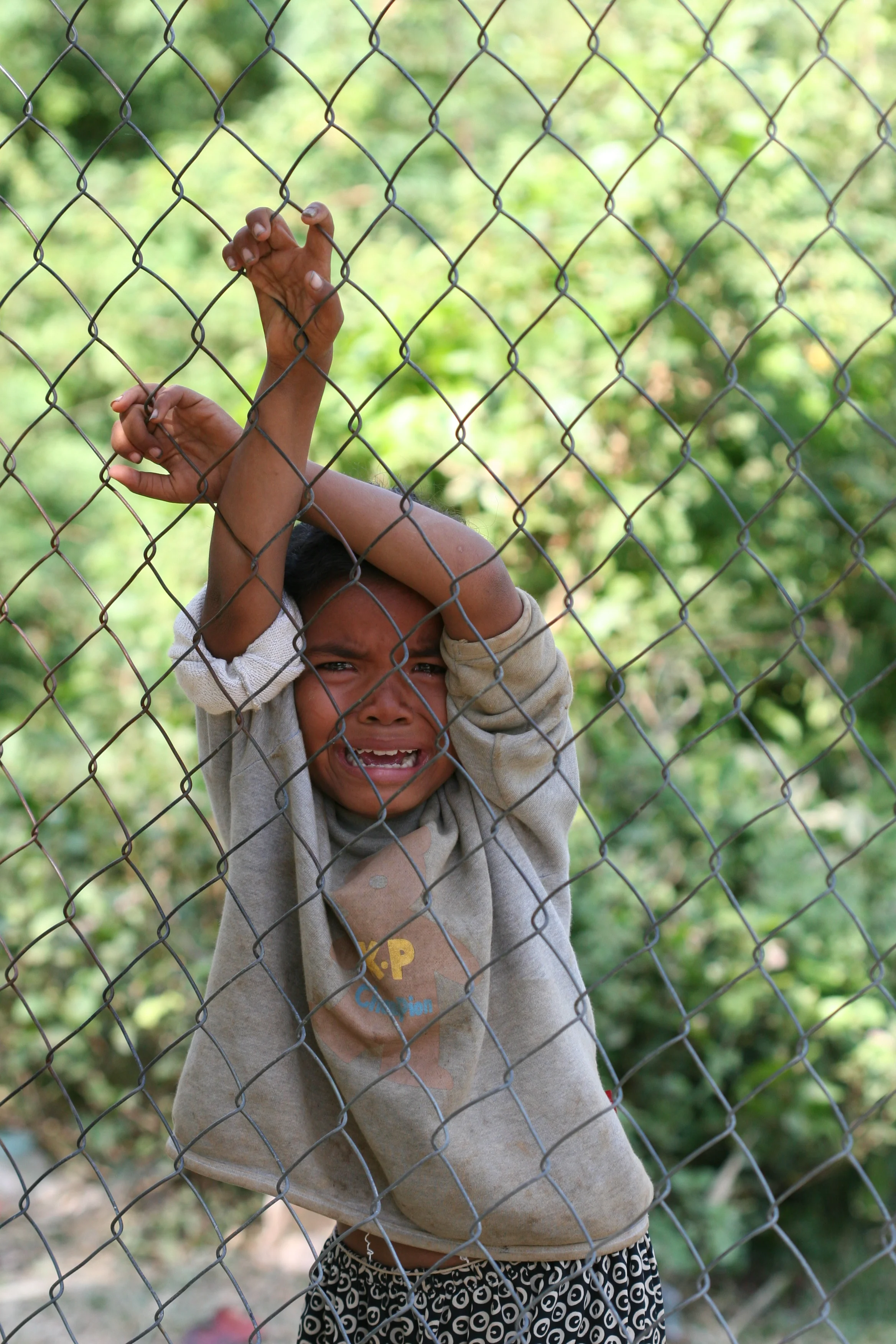 beggar child crying at killing fields, cambodia