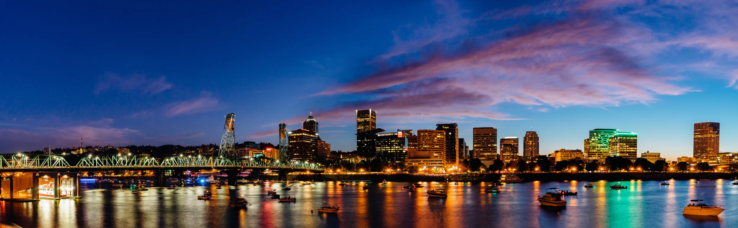 A panoramic view of downtown Portland at dusk from across the Willamette River 