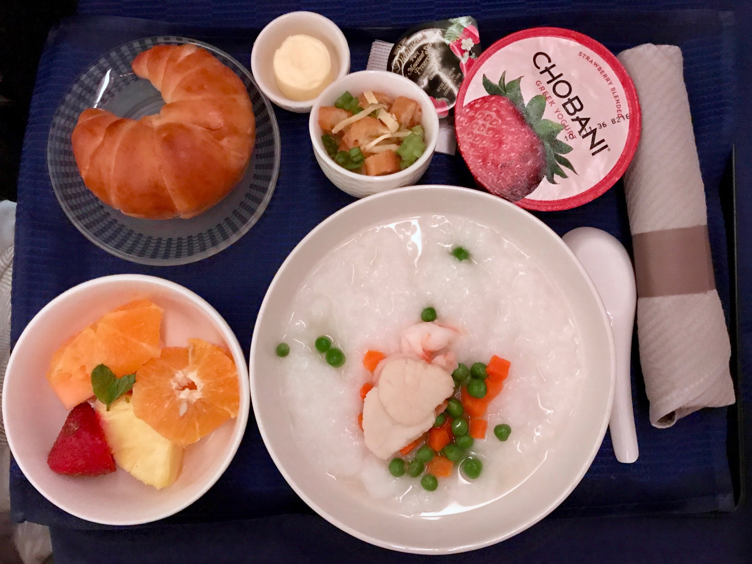 Seafood congee and fresh fruits for breakfast.
