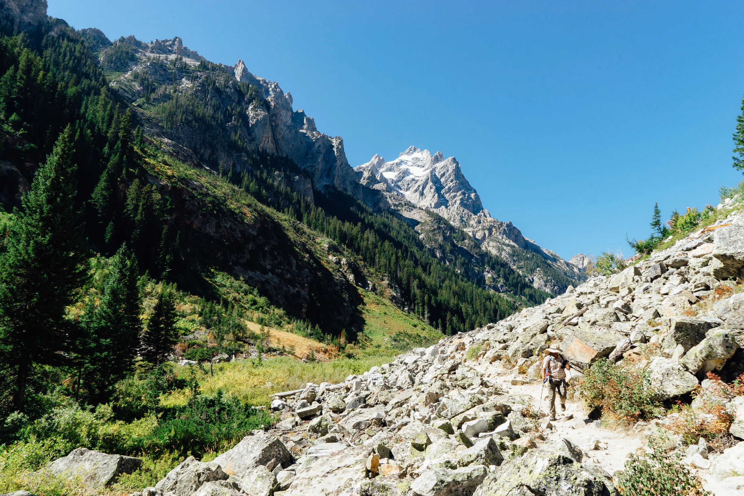 The 14-mile round trip Cascade Trail cuts through the Teton range alongside the Cascade River. It is one of the most popular hiking trail in the park. However, the trail gets more peaceful if you are willing to walk further than the Inspiration Point.