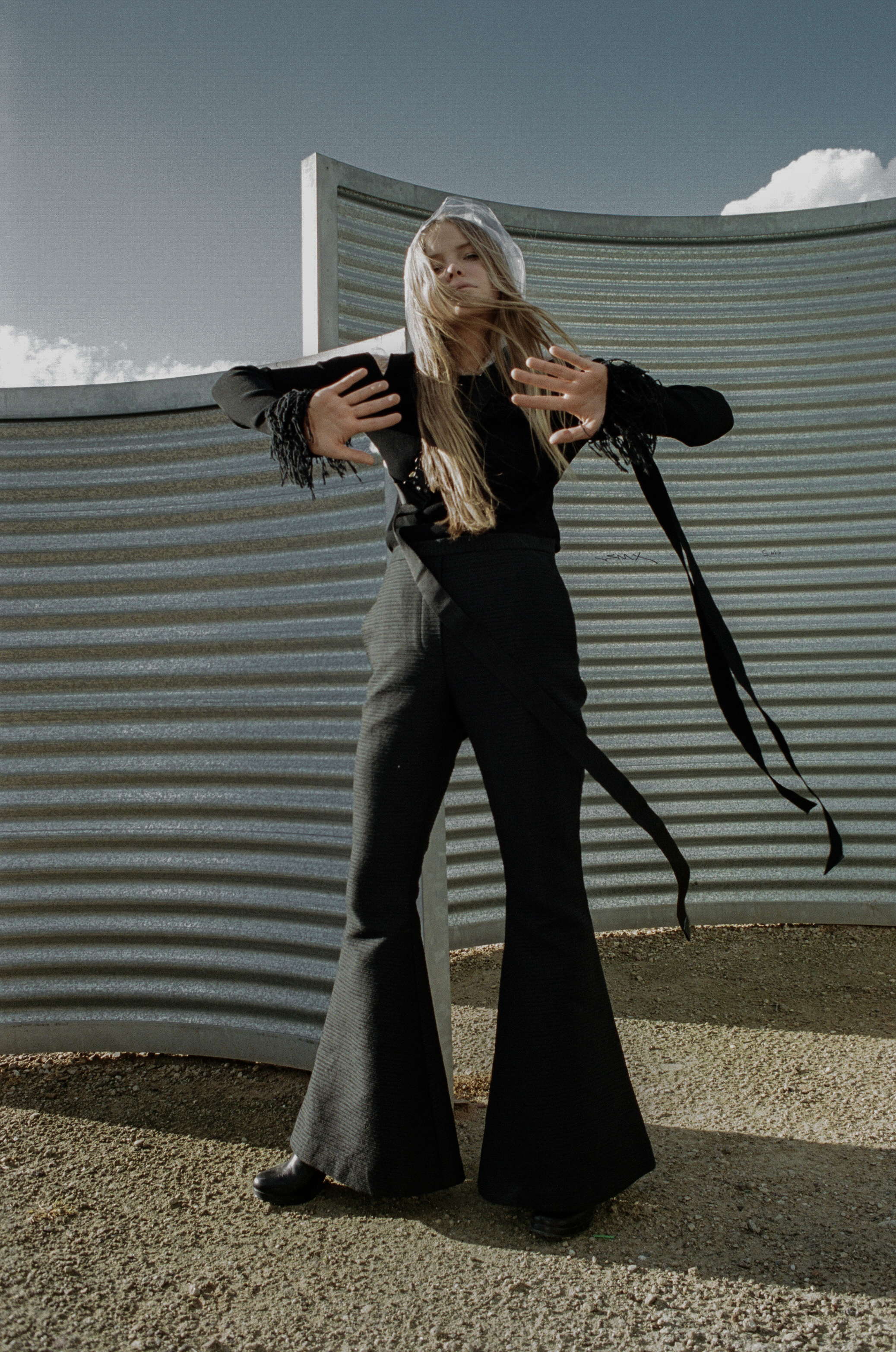 top + choker ALYX STUDIO , raincoat STYLIST'S OWN, trousers ELLERY, boots STOLEN GIRLFRIENDS CLUB