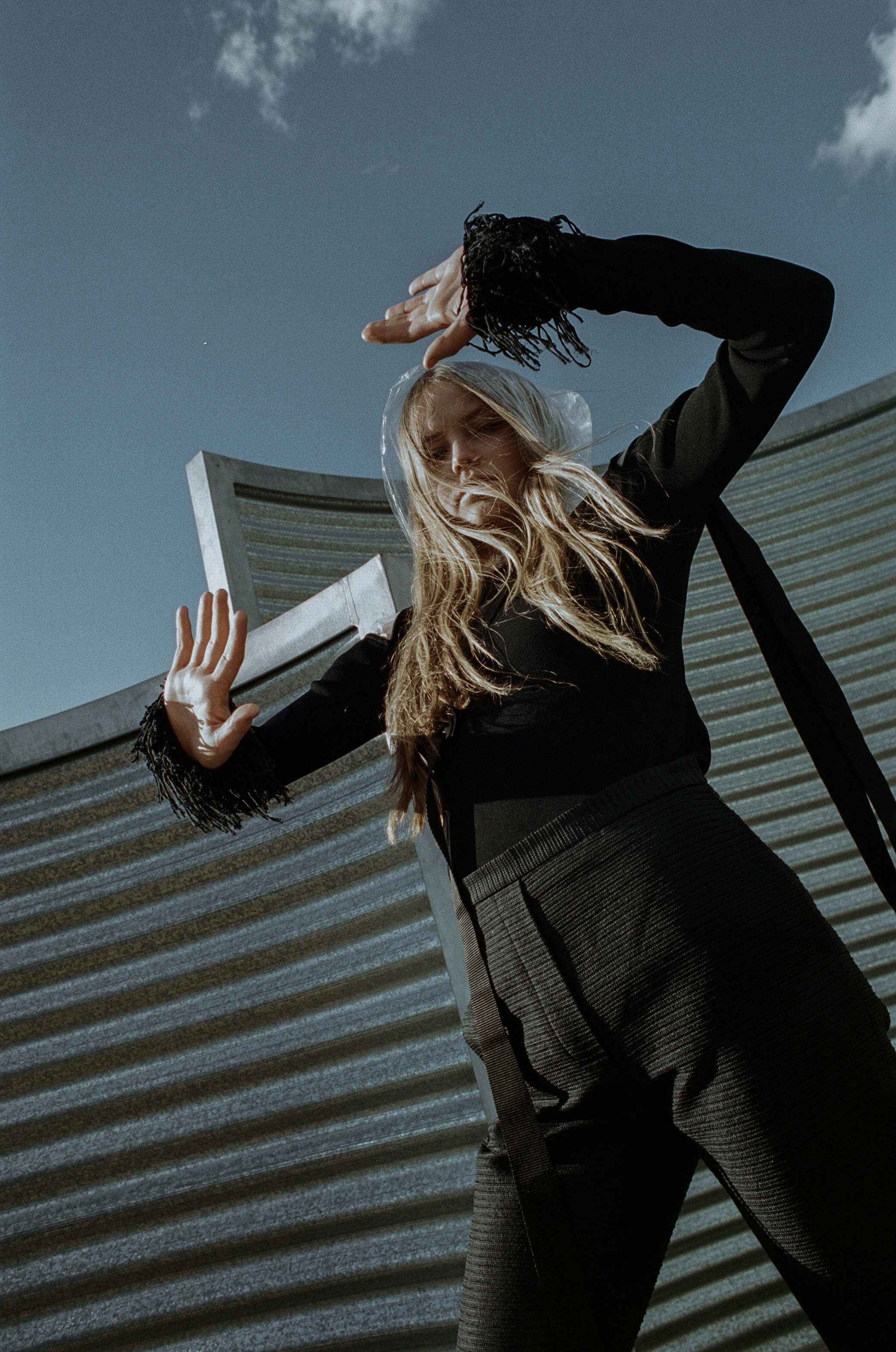 top + choker ALYX STUDIO , raincoat STYLIST'S OWN, trousers ELLERY, boots STOLEN GIRLFRIENDS CLUB
