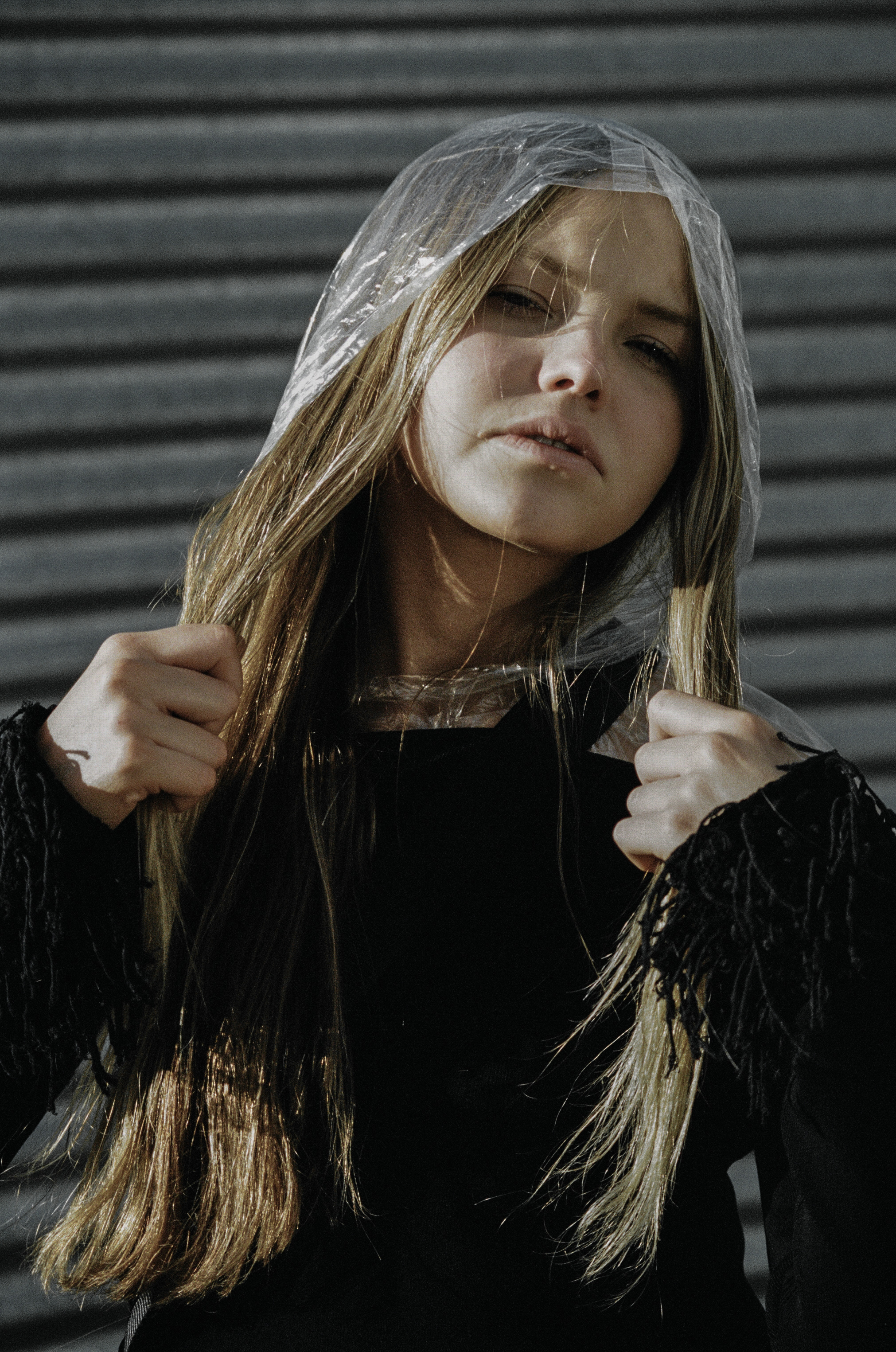 top + choker ALYX STUDIO , raincoat STYLIST'S OWN, trousers ELLERY, boots STOLEN GIRLFRIENDS CLUB