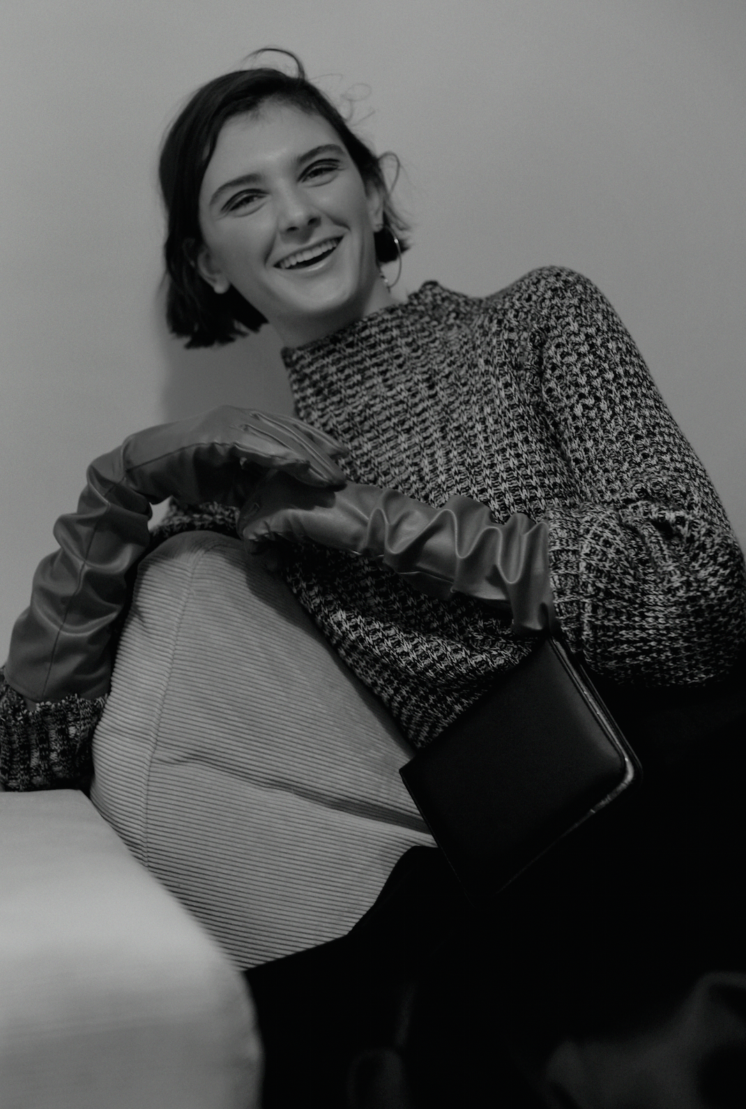 top JULIAN ZIGERLI , bag PERSEPHONI , gloves STYLIST'S OWN, earring JUSTINE CLENQUET