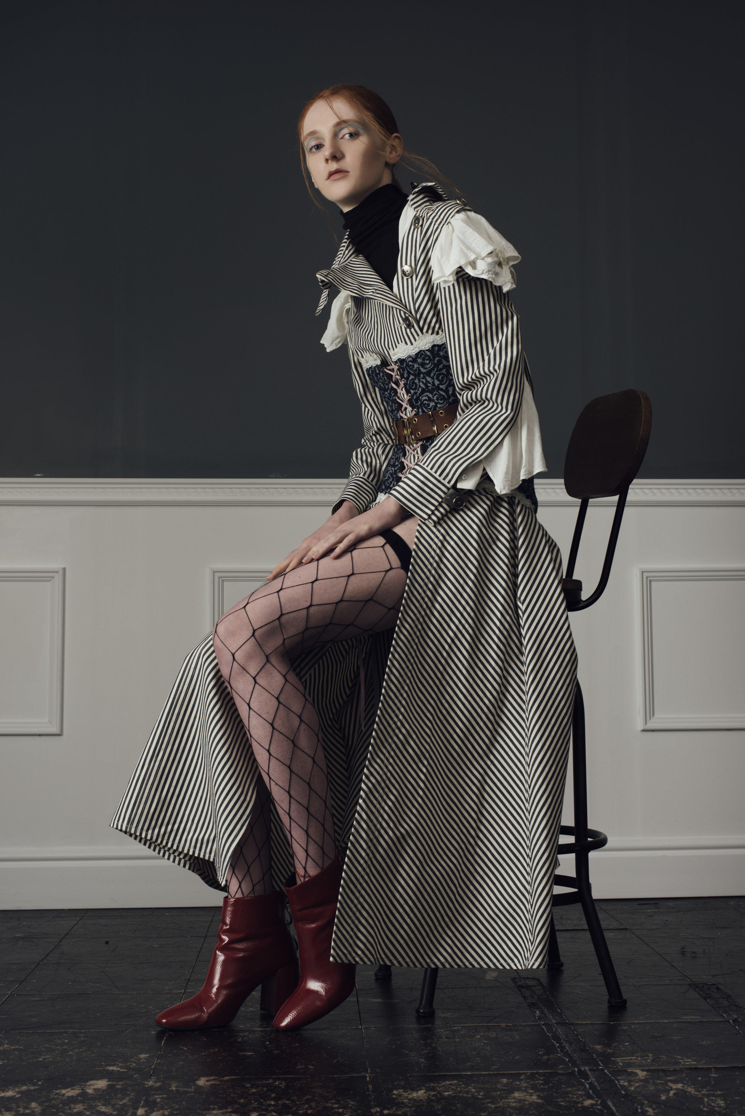 jumper UNIQLO , blouse STYLIST’S OWN, corset COSTUME STUDIO Vintage dior belt MODES AND MORE, coat CONSTANCE BLACKBALLER , boots STYLIST’S OWN